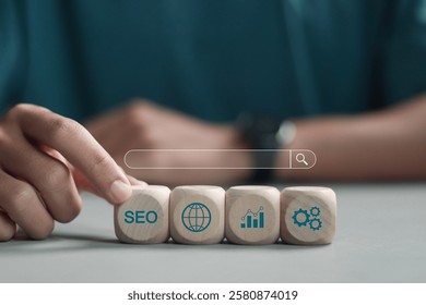 SEO search engine optimization concept, Marketing ranking traffic website, internet technology for business company. Person with SEO icon on wooden block