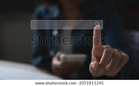 SEO Search engine optimization concept. Women using mobile smart phone and laptop computer searching information data on internet network, touching on tool bar on virtual screen
