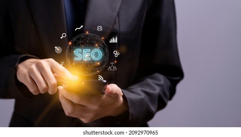 SEO Search Engine Optimization, Hand holding mobile phone and concept for the best promoting ranking traffic on website, optimizing your website to rank in search engines or SEO. - Shutterstock ID 2092970965