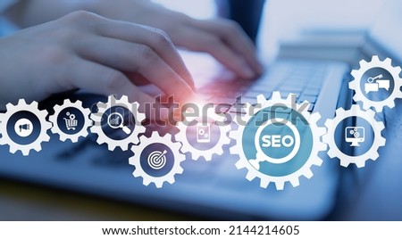 SEO, Search Engine Optimization ranking concept.  Digital marketing strategy of promote traffic to website. Working on computer with the icon of magnifying glass, abbreviation SEO and SEO symbol. 