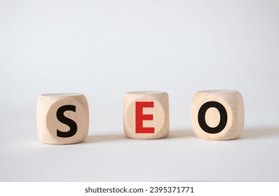 SEO - Search Engine Optimization symbol. Wooden blocks with words SEO. Beautiful white background. Business and SEO concept. Copy space.