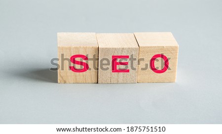 SEO search engine optimization, text on wooden cubes, on a gray table, the concept of minimalism. Idea, vision, strategy, analysis, Keyword and content concept.