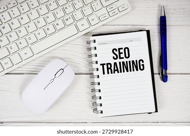 SEO Training text with keyboard and wireless mouse on wooden background