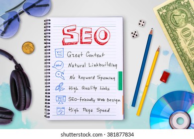 Seo and web development tips collection in a notebook, creative idea concept background with watercolor splashes, cd disk, headphones, dollar, dice photo collage, top view, flat lie