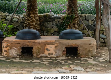 Seosan, South Korea; August 14, 2020: For Editorial Use Only.Old Fashioned Cooking Cauldrons Set In Primitive Earth Oven At Haemieupseong Fortress.