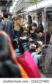 SEOUL, KOREA - 27 APR 2012: View of passengers in Seoul Metropolitan Subway. It consisting of 23 rapid transit, light metro, commuter rail and people mover lines located in northwest South Korea.