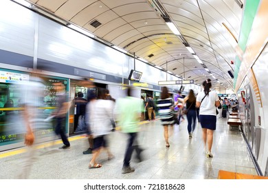 SEOUL, KOREA - AUGUST 12, 2015: Lots of different people going forth and back on a subway platform - Seoul, South Korea