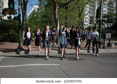 SEOUL, KOREA - MAY 2, 2012: A Group Of Korean Students In Uniform Crossing The Street To School.