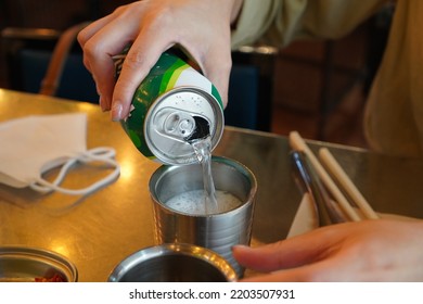 Seoul, Korea - Sep 02 2022: Pouring Cider Can To A Cup. Drinking Soft Drink For Refreshment.