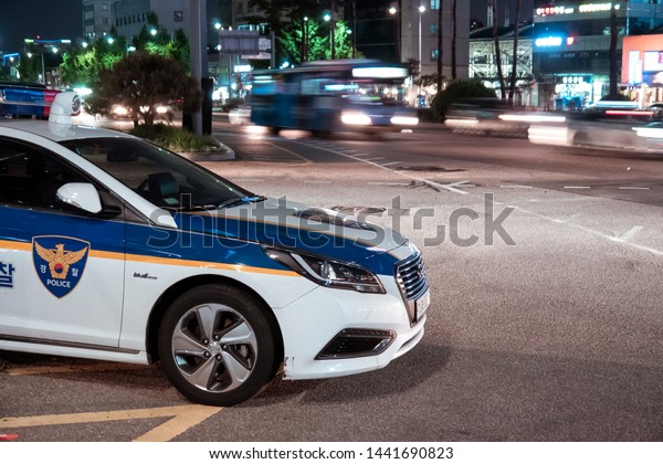 Seoul,\
South Korea - 08.05.18: a police car is on duty at night. police\
car parked on a busy street in the evening. policing on the\
highway. police are on duty in the night\
city