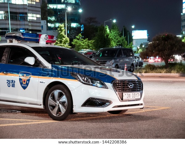 Seoul,\
South Korea - 08.05.18: a police car is on duty at night. police\
car parked on a busy street in the evening. policing on the\
highway. police are on duty in the night\
city
