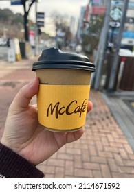 Seoul, South Korea - 21th December 2021 : Franchise Coffee, Mc Cafe. Walking On The Street With Coffee After Lunchtime.