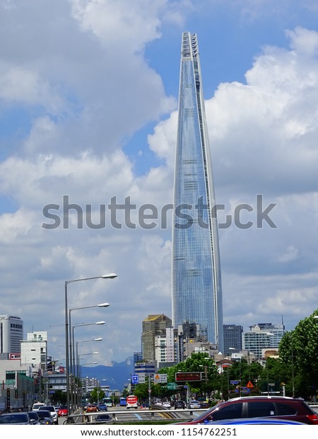Seoul, South Korea, August 11, 2018, There is\
Lotte world tower in a street of Seoul, Korea, on a clean and very\
hot blue sky day.\
