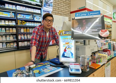 SEOUL, SOUTH KOREA - CIRCA MAY, 2017: Indoor Portrait Of Worker At 7-Eleven Convenience Store. 7-Eleven Is An International Chain Of Convenience Stores.