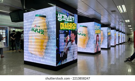 Seoul, South Korea - July 12 2022: Gangnam Metro Station Platform And Banana Flavor Milk Ad On Digital Billboards. 