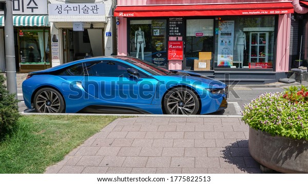 Seoul, South\
Korea - July 29, 2019: \
Blue car BMW i8 side view, stands by the\
glass wind of a shop in downtown\
Seoul