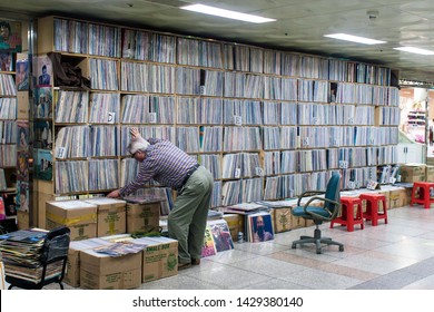 Seoul, South Korea - June 2010: Old Man Is Digging In Large Records Collection