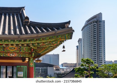 Seoul, South Korea - October 15, 2017: Colorful traditional Korean tile roof of Bongeunsa Temple and modern buildings at Gangnam District. Bongeunsa Temple is a popular tourist attraction of Asia.