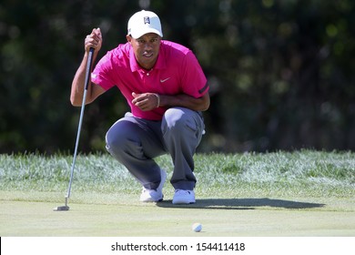 Sep 15, 2013; Lake Forest, IL, USA; Tiger Woods lines up a putt on the third green during the third round of the BMW Championship at Conway Farms Golf Club.