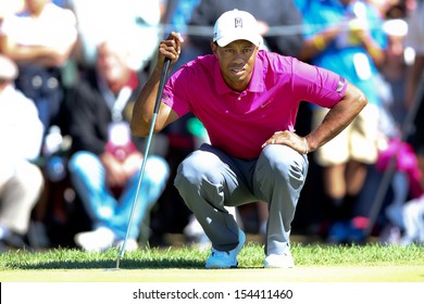 Sep 15, 2013; Lake Forest, IL, USA; Tiger Woods lines up a putt on the second green during the third round of the BMW Championship at Conway Farms Golf Club.