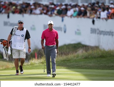Sep 15, 2013; Lake Forest, IL, USA; Tiger Woods (r) approaches the 18th green with caddie Joe LaCava during the third round of the BMW Championship at Conway Farms Golf Club.
