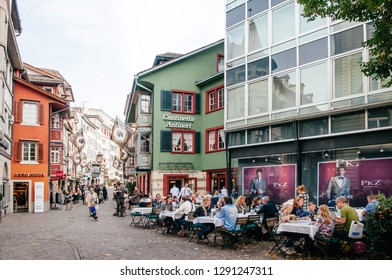 SEP 28,2013 Zurich, Switzerland - Beautiful Colourful Old Vintage Buildings And Street Cafe With Tourists Sitting Outside In Zurich Old Town Altstadt Area