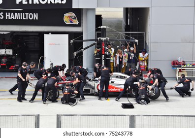 SEPANG F1 CIRCUIT, MALAYSIA - APRIL 8: Jenson Button of Vodafone McLaren Mercedes is in the pit stop at PETRONAS Malaysia Grand Prix during qualifying session on April 8, 2011 in Sepang, Malaysia