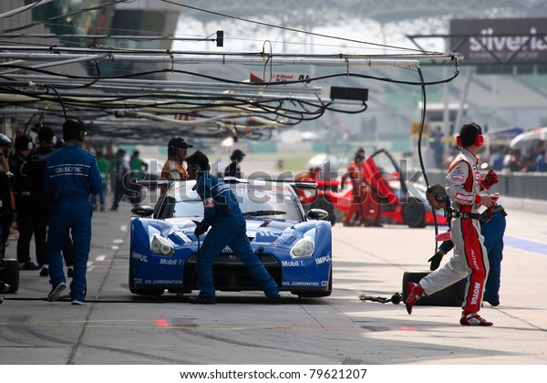 SEPANG - JUNE 19: Pit crew works on Team\
Impul\'s Nissan GT-R R35 car during the practice round of the Japan\
SUPER GT Round 3 race on June 19, 2011 in Sepang international\
Circuit, Malaysia.