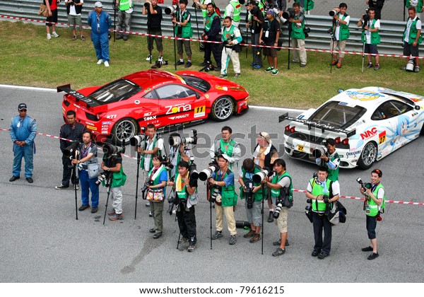 SEPANG - JUNE\
19: Press photographers prepare to shoot the prize giving ceremony\
at the podium after the race of the Japan SUPER GT Round 3 race on\
June 19, 2011 in Sepang,\
Malaysia.