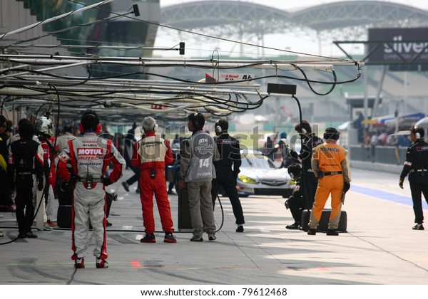 SEPANG - JUNE 19: Team mechanics working in the\
pitlane during the qualifying sessions of the Japan SUPER GT Round\
3 at the Sepang International Circuit on June 19, 2011 in Sepang,\
Malaysia.