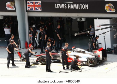 SEPANG, MALAYSIA - APRIL 8: Vodafone McLaren Mercedes' mechanics practice pit stops on Lewis Hamilton's car on practice day of the Petronas Malaysian F1 Grand Prix on April 8, 2011 in Sepang, Malaysia.