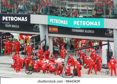 SEPANG, MALAYSIA - MARCH 25: Ferrari F1 Team crews does pit-stop practice at the 2012 F1 Petronas Malaysian Grand Prix at Sepang International Circuit on March 25, 2012 in Sepang, Malaysia