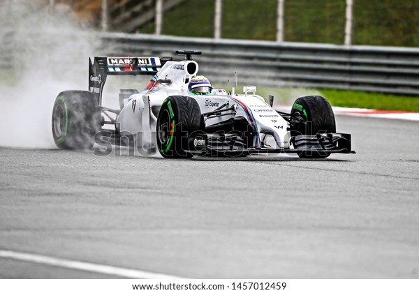 SEPANG, MALAYSIA : Motion blur. Grain. Noise.\
Williams Martini Racing F1 team driver, Felipe Massa, perform of\
2014 FORMULA 1, Petronas Grand Prix at Sepang International Circuit\
on March 30, 2014
