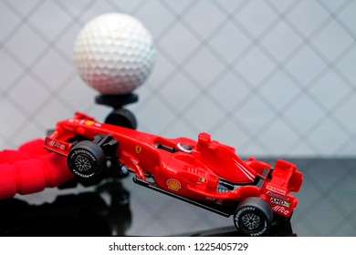 SEPANG, MALAYSIA - NOVEMBER 9, 2018- A Model Of The Ferrari Formula 1 Car. Toy Ferrari F1 F2008 With Ball Golf On Studio Background.  Selective Focus.