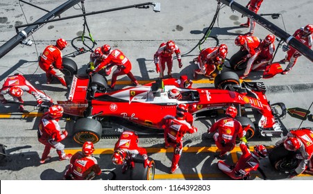 SEPANG, MALAYSIA - OCTOBER 02, 2016 : Team Members Of Kimi Raikkonen Of Scuderia Ferrari Change Tyre At Pit Stop During The Malaysia Formula One (F1) Grand Prix At Sepang International Circuit (SIC).