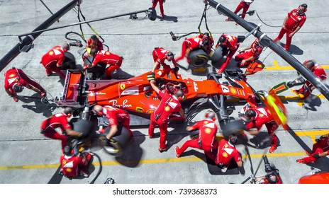 SEPANG, MALAYSIA : SEPTEMBER 30, 2017 : Team members of Kimi Raikkonen of Scuderia Ferrari practice a pit stop ahead of the Malaysia Formula One (F1) Grand Prix at Sepang International Circuit (SIC).