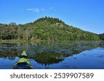 SEPAQ Orford national park kayak exploration of Cherry pond and Serpentine hill on the background. Etang aux cerises and coline Serpentine with yellow kayak