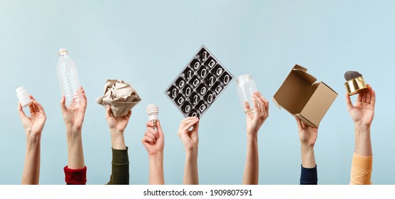 Separate collection of garbage. Human hands holding plastic, glass, metal, paper, lightbulb stuff for recycle. Eco friendly people. Human's hand holds recyclable waste on blue background. Zero waste