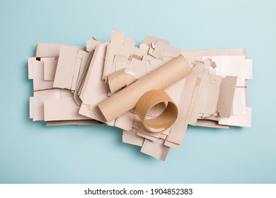 Separate Collection Of Grey Cardboard. Paper Garbage. Paper Stuff For Recycle On Blue Background. Eco Friendly Concept. Recyclable Paper Waste On Blue. Zero Waste. Recycled Product, Craft Cardboard