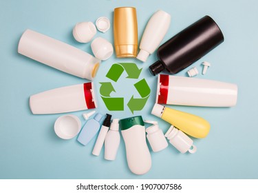 separate collection of sorted HDPE bottles from cosmetics for recycling in for of circle. High-Density Polyethylene recyclable cosmetics package on blue background. Plastic garbage. Save the planet - Powered by Shutterstock