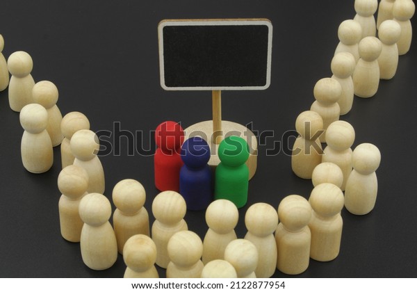 Separate people with\
condition on board. Many wooden figures and blank blackboard with\
space for text.