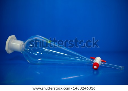 The separating funnel is used to extract solvent from solvent. In a chemical laboratory Blue background
