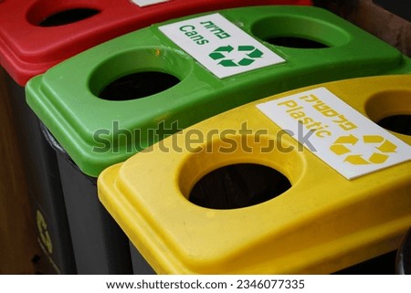 Separating garbage into different containers. Trash cans for sorted waste in Israel. Colors of each box indicates type of trash for being stored. Each fraction of the garbage can be used for recycling