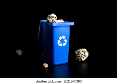 Separation paper recycle. Blue dustbin for recycle paper trash isolated on black background. Bin container for disposal garbage waste and save environment