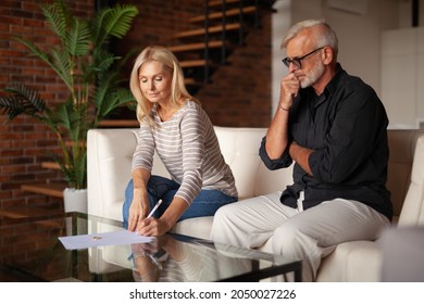 Separation of property of a mature couple. Senior husband and wife sign a divorce agreement. Relationship crisis, breakup. - Shutterstock ID 2050027226