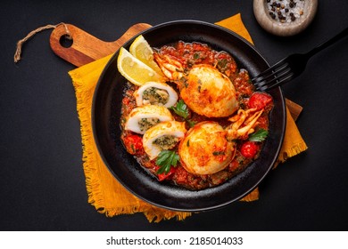 Sepia, Calamari Or Cuttlefish Stuffed With Swiss Chard, Bread Crumbs And Parmesan Cheese And Cooked In Tomato Sauce. Black Background. Directly Above.