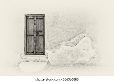 Sepia image of a traditional Arabian carved wooden door with a step in a crumbling plaster wall of a restored house in the Arabian Gulf.