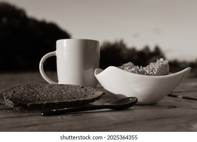 Sepia Style Still Life Photography Of Fresh Honey Green In White Bowl, Rye Bread And Milk Mug.