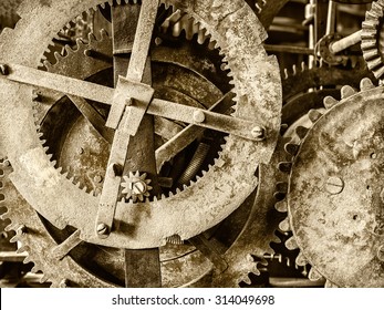Sepia toned detail of a rusty ancient church clock mechanism