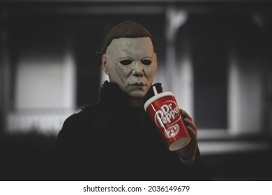 SEPT 3 2021: Halloween slasher Michael Myers drinking Dr Pepper soda in front of the Myers house in Haddonfield  - Neca action figure
